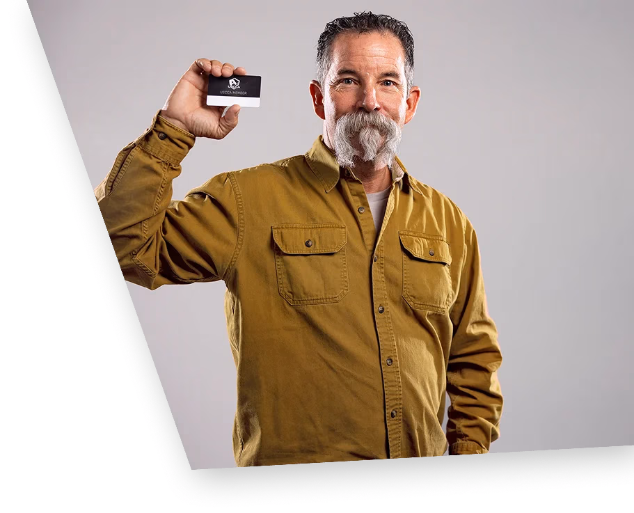 A USCCA member holding his membership card