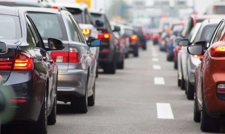 Two lanes of congested city traffic showing brake lights extending as far as the eye can see. Prime breeding grounds for road rage.
