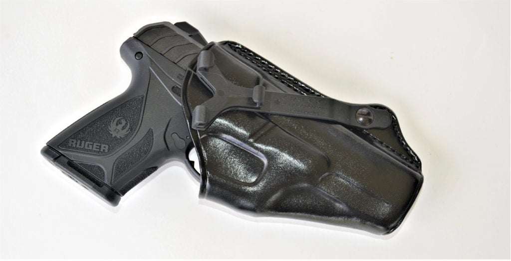 A black Ruger Security-9 semiautomatic pistol encased in a black leather holster from Galco Gunleather