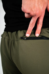 A zippered back pocket on the green Arrowhead Carrier Shorts.