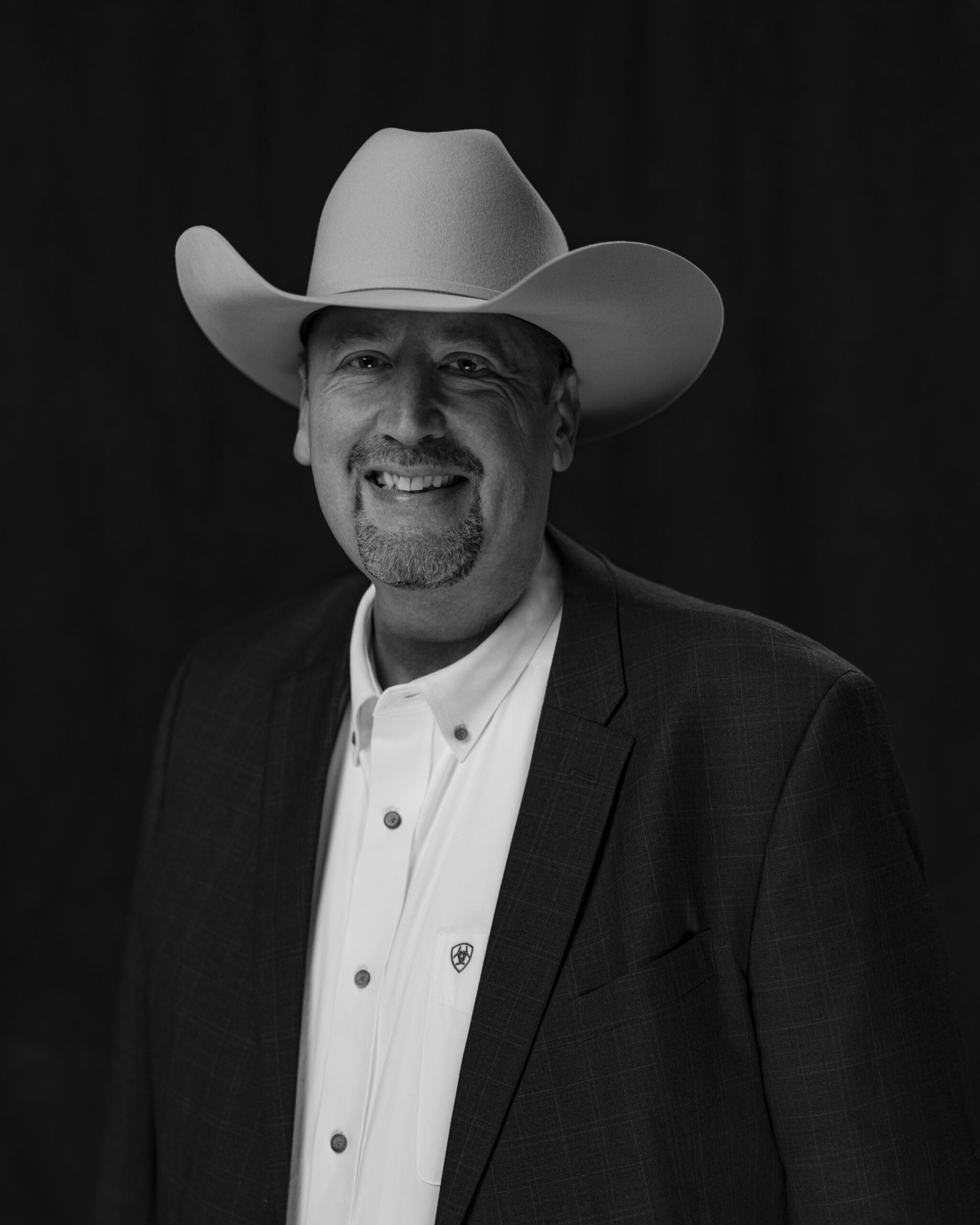 portrait of Kyle Wierenga in a suit and cowboy hat