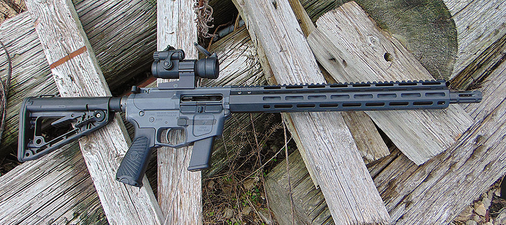 A Wilson Combat AR-9 carbine lying on top of a woodpile.
